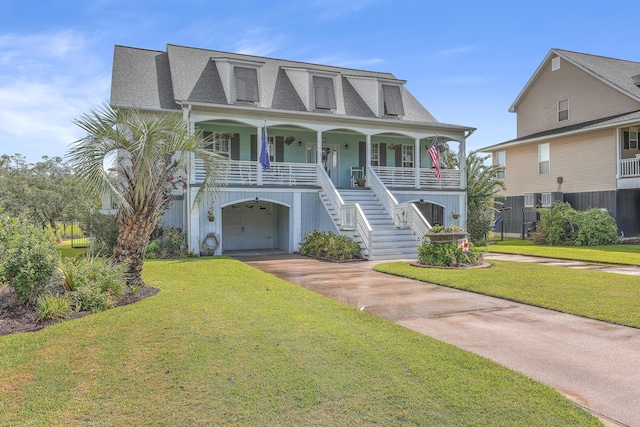 view of front of house featuring a front yard, a porch, and a garage