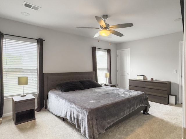 bedroom featuring light colored carpet and ceiling fan