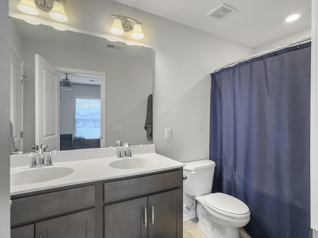 full bathroom featuring toilet, double vanity, a ceiling fan, and a shower with shower curtain
