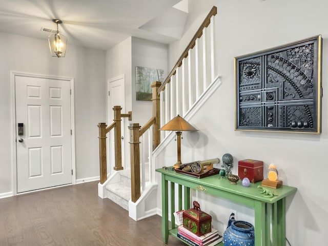 entrance foyer featuring wood finished floors, baseboards, and stairway