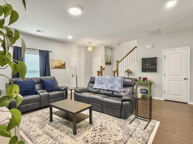 living area featuring stairs, baseboards, wood finished floors, and recessed lighting