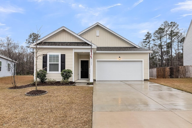 view of front of home featuring a front lawn, roof with shingles, driveway, and an attached garage