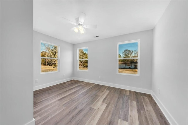 empty room featuring ceiling fan and light hardwood / wood-style flooring