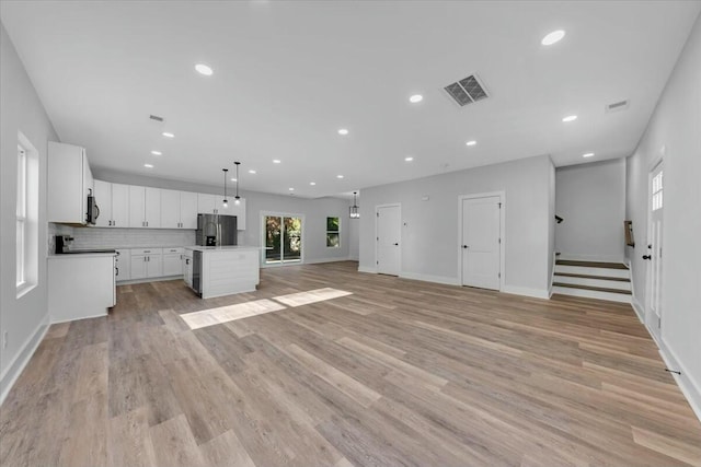 unfurnished living room featuring light wood-type flooring