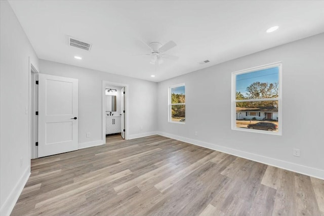 unfurnished bedroom with ceiling fan, light hardwood / wood-style floors, and ensuite bath