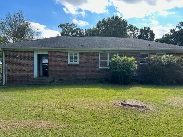 rear view of property featuring a yard