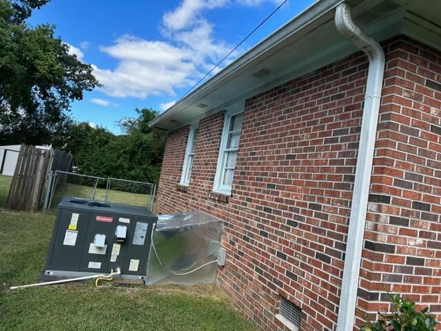 view of side of property with a yard