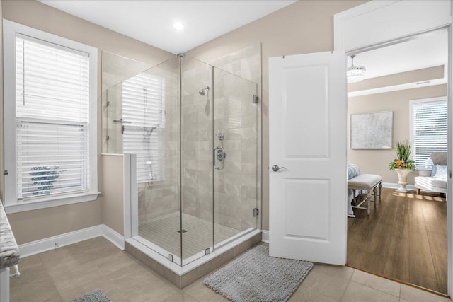 bathroom featuring baseboards, a stall shower, connected bathroom, and recessed lighting