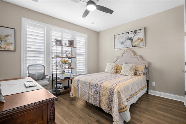 bedroom with wood finished floors, a desk, baseboards, and a ceiling fan