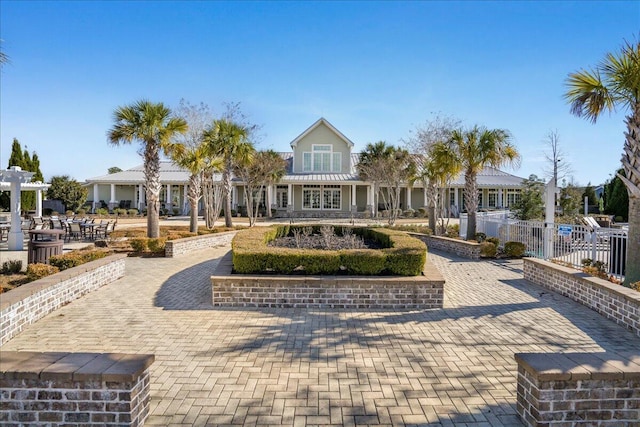 view of community featuring fence and a pergola