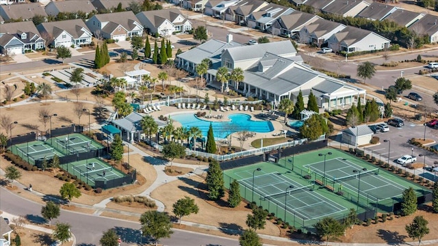 aerial overview of property's location featuring a pool and nearby suburban area