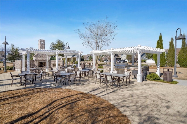 view of home's community featuring a pergola, a patio, and outdoor dining space