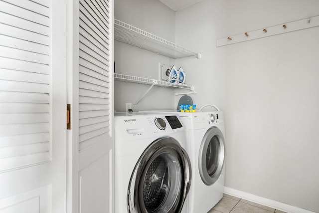 9002 Palmetto Dr Unit 420, Isle Of Palms, SC 29451 - washroom with washer and clothes dryer, light tile patterned flooring, and baseboards