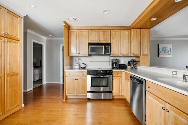 9002 Palmetto Dr Unit 420, Isle Of Palms, SC 29451 - kitchen with appliances with stainless steel finishes, light brown cabinets, crown molding, wood finished floors, and recessed lighting