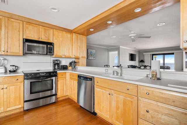 9002 Palmetto Dr Unit 420, Isle Of Palms, SC 29451 - kitchen with appliances with stainless steel finishes, ornamental molding, light wood finished floors, light countertops, and a sink