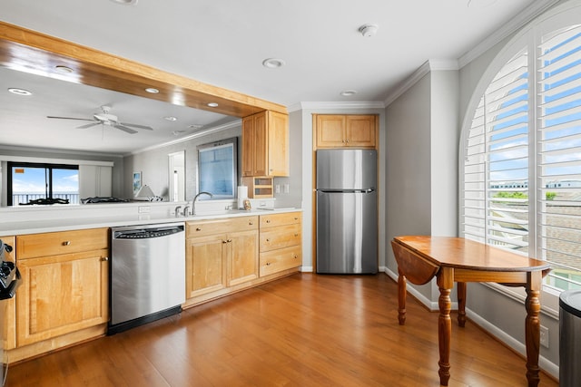 9002 Palmetto Dr Unit 420, Isle Of Palms, SC 29451 - kitchen with stainless steel appliances, crown molding, wood finished floors, light brown cabinets, and recessed lighting