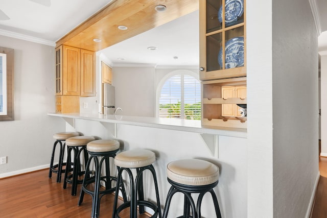 9002 Palmetto Dr Unit 420, Isle Of Palms, SC 29451 - kitchen featuring ornamental molding, wood finished floors, baseboards, freestanding refrigerator, and glass insert cabinets