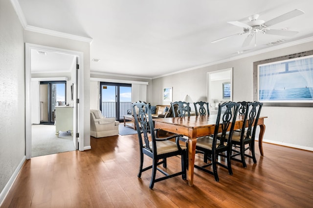 9002 Palmetto Dr Unit 420, Isle Of Palms, SC 29451 - dining area featuring wood finished floors, baseboards, crown molding, and ceiling fan