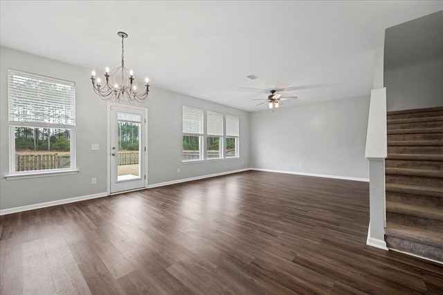 unfurnished living room with dark wood-type flooring and ceiling fan with notable chandelier