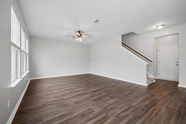 empty room with dark wood-type flooring and ceiling fan