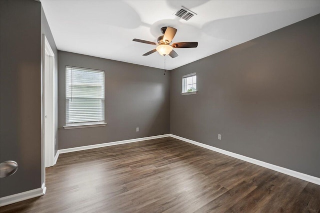 unfurnished room featuring ceiling fan and dark hardwood / wood-style flooring