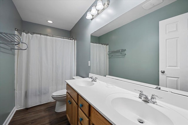 bathroom featuring vanity, toilet, and hardwood / wood-style floors