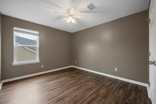 unfurnished room featuring dark wood-type flooring and ceiling fan