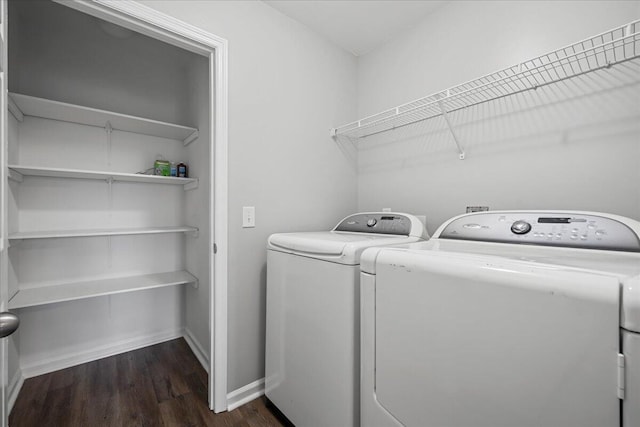 clothes washing area featuring washer and dryer and dark hardwood / wood-style flooring