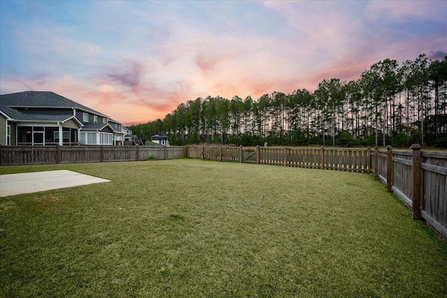 yard at dusk with a patio area