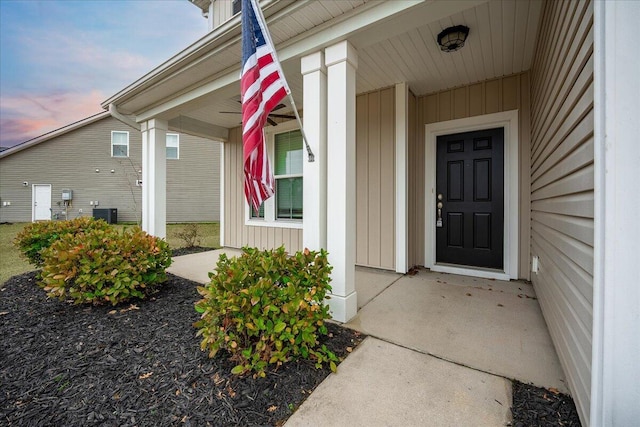 exterior entry at dusk with a porch and cooling unit