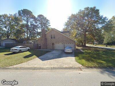 8194 Courtwood Rd, North Charleston, SC 29406 - view of home's exterior featuring driveway, a garage, and a lawn