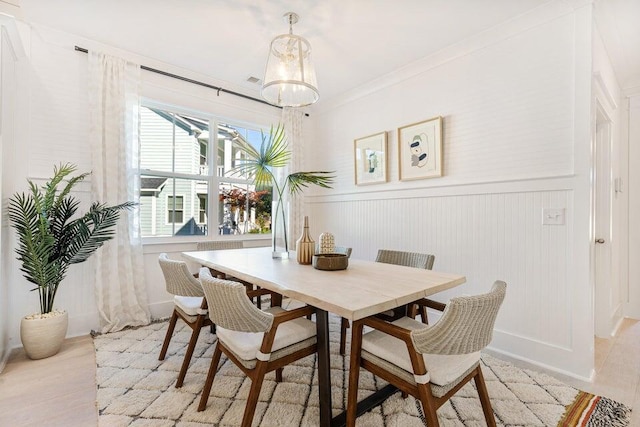 dining space featuring crown molding