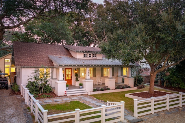 view of front of home with a porch and a front yard