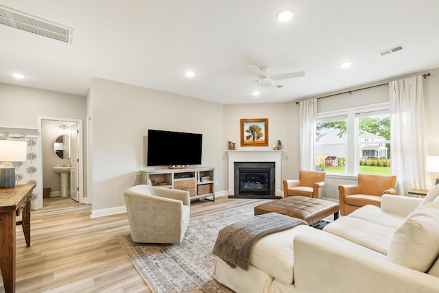 3010 Grinnell St, Johns Island, SC 29455 - living room featuring light wood-type flooring, ceiling fan, recessed lighting, baseboards, and a glass covered fireplace