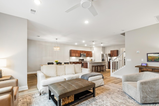 3010 Grinnell St, Johns Island, SC 29455 - living room with light wood-style flooring, a ceiling fan, baseboards, stairway, and recessed lighting
