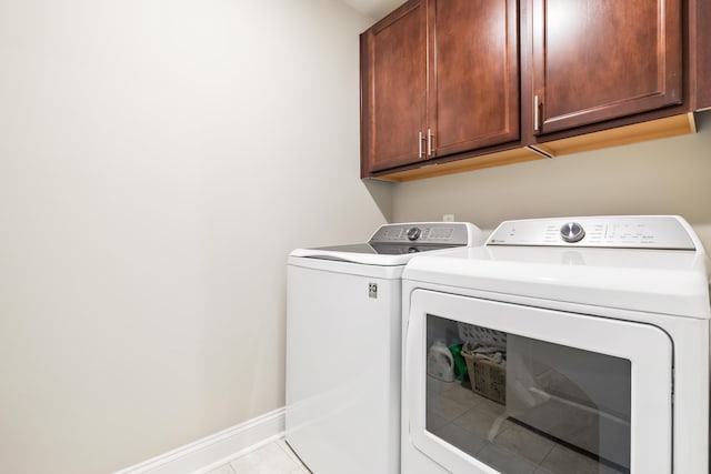 3010 Grinnell St, Johns Island, SC 29455 - laundry area featuring cabinet space, separate washer and dryer, baseboards, and tile patterned flooring