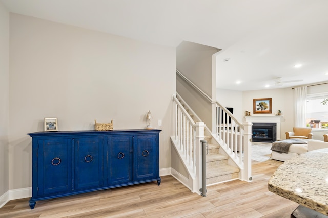 3010 Grinnell St, Johns Island, SC 29455 - stairway with a glass covered fireplace, wood finished floors, ceiling fan, recessed lighting, and baseboards