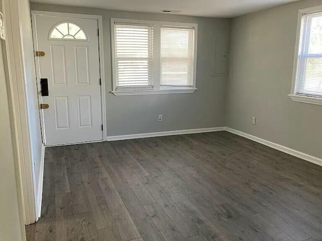 foyer featuring dark wood-style floors and baseboards