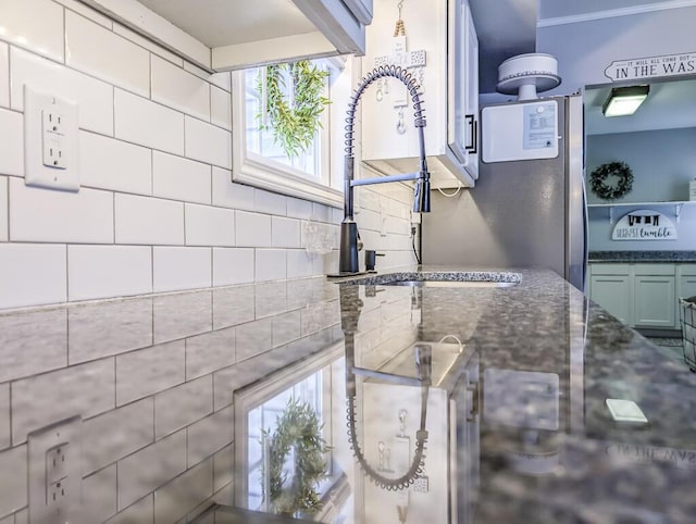 49 Auld Brass Rd, Walterboro, SC 29488 - kitchen view of a sink, dark stone counters, and tasteful backsplash