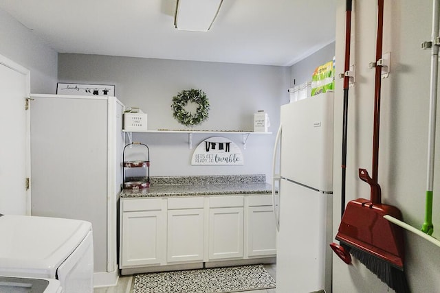 49 Auld Brass Rd, Walterboro, SC 29488 - kitchen with freestanding refrigerator, white cabinets, washing machine and clothes dryer, and open shelves