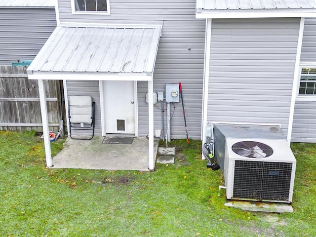 49 Auld Brass Rd, Walterboro, SC 29488 - view of exterior entry featuring central AC unit, metal roof, and a patio area