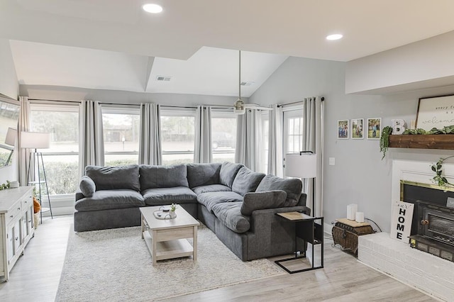 49 Auld Brass Rd, Walterboro, SC 29488 - living area featuring light wood-type flooring, lofted ceiling, a brick fireplace, healthy amount of natural light, and recessed lighting
