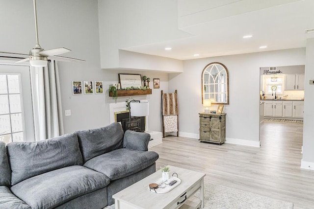 49 Auld Brass Rd, Walterboro, SC 29488 - living room with light wood-style floors, baseboards, recessed lighting, a towering ceiling, and ceiling fan