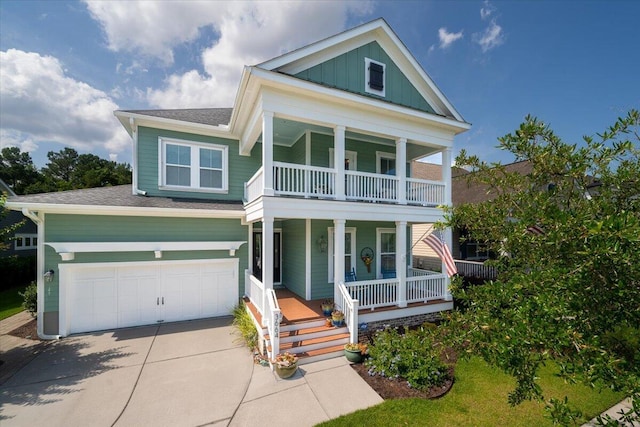 view of front of property featuring a balcony, a garage, covered porch, and driveway