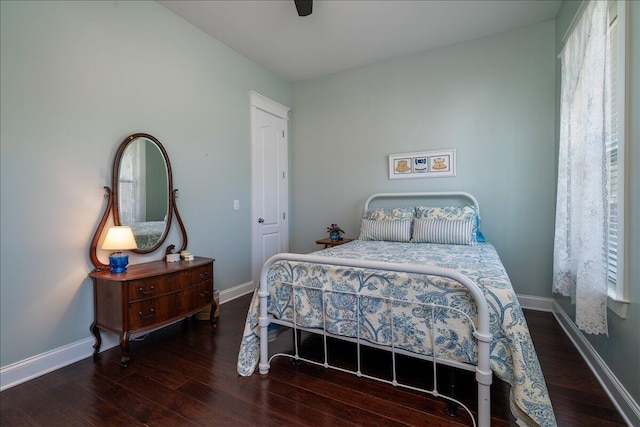 bedroom with wood finished floors, baseboards, and ceiling fan