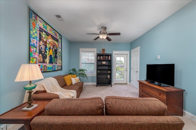 living area with visible vents, baseboards, a ceiling fan, and carpet flooring