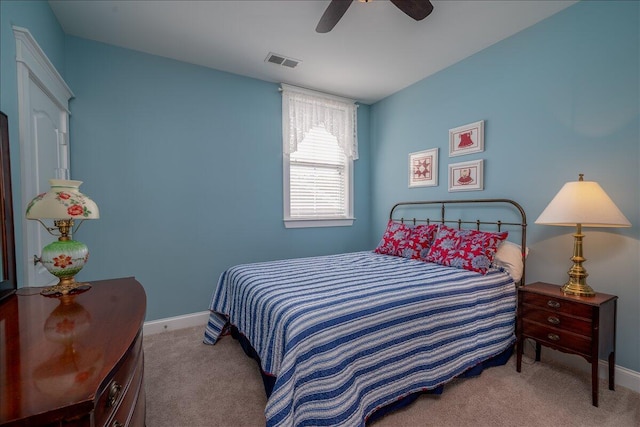 bedroom featuring visible vents, baseboards, carpet, and a ceiling fan