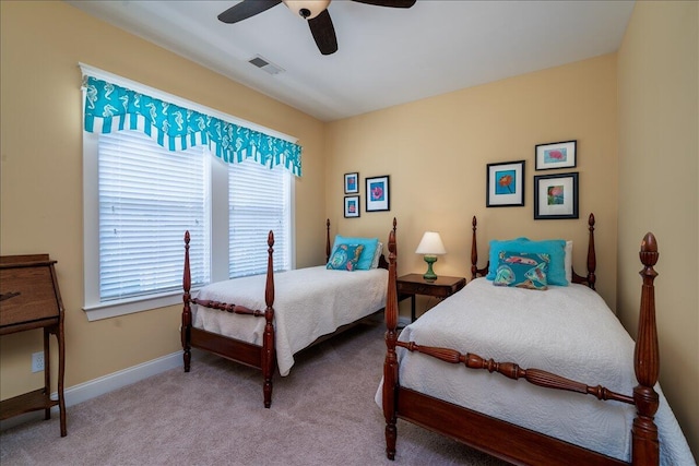 carpeted bedroom featuring visible vents, baseboards, and ceiling fan