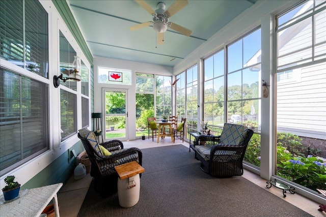 sunroom / solarium featuring ceiling fan