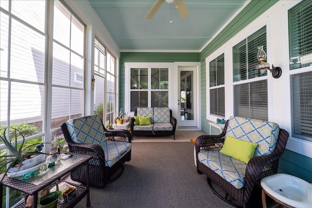 sunroom / solarium with a ceiling fan